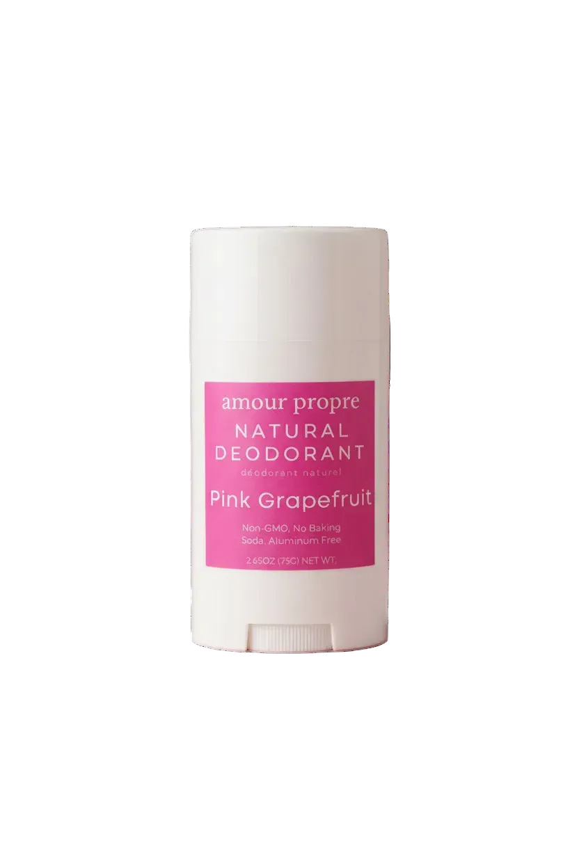 A white plastic stick deodorant container with a pink label reading 'amour propre NATURAL DEODORANT' and 'Pink Grapefruit'.