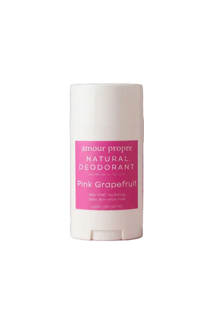 A white plastic stick deodorant container with a pink label reading 'amour propre NATURAL DEODORANT' and 'Pink Grapefruit'.