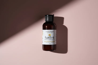 Lustrehand lotion product bottle on a textured surface