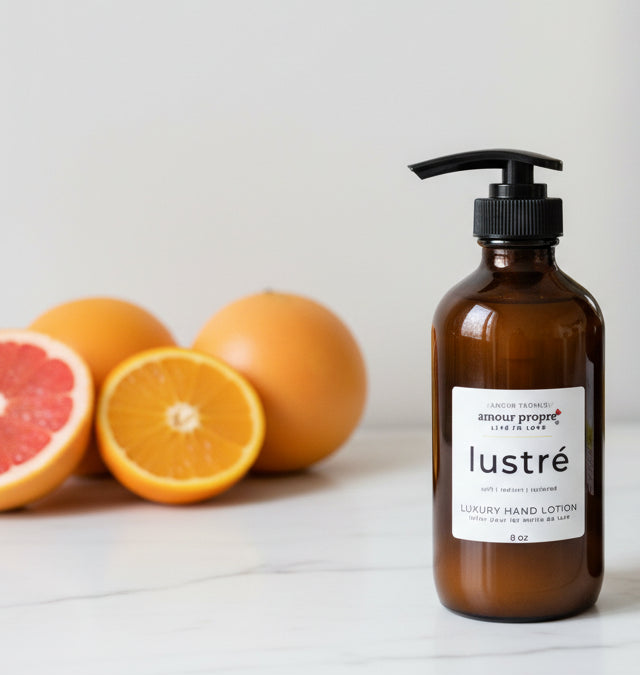 Amour Propre Lustré hand lotion bottle with oranges on a light background